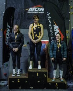 An image of first place Open A female winner Emma Horan, second place Rose Weller, and third place Laura Steele-Hicks on the podium.