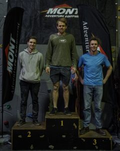 An image of first place Open A male winner Thomas Farrell, second place Dan Fisher, and third place Callum Hyland on the podium.