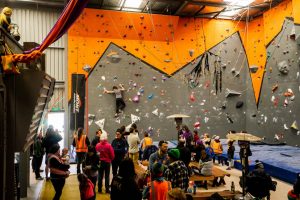 A wide shot showing a busy gym full of people during the 2018 ACT State Bouldering Titles. Photo by Casey Dubois.