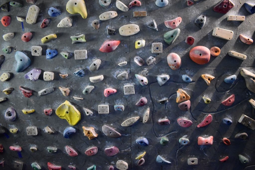 A close up of the holds on the steep bouldering wall, which are mixed at random and are not aligned to make any specific routes - climbers can choose and design their own routes suited to their training.