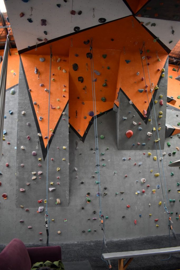 The next section of climbing walls, designed with varying degrees of incline. Quick draws placed on the wall indicate places where qualified climbers can lead climb.